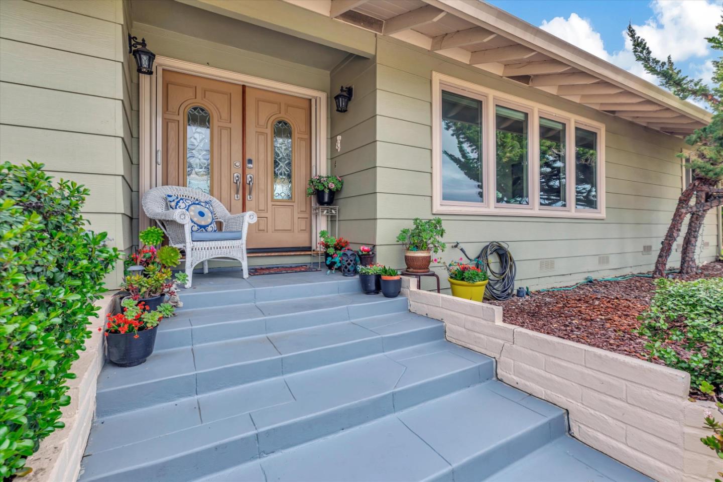 a view of a house with potted plants