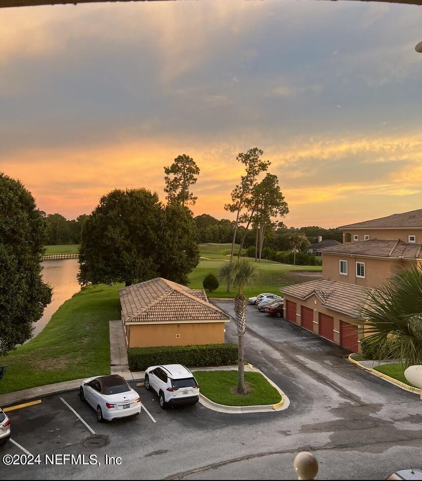 a view of a street with a yard