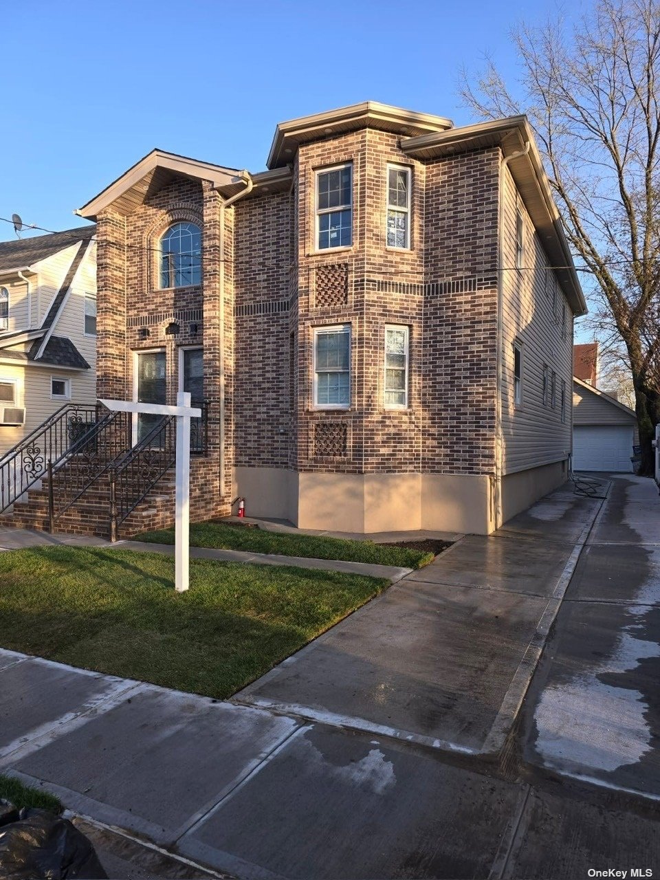 a front view of a house with a garden