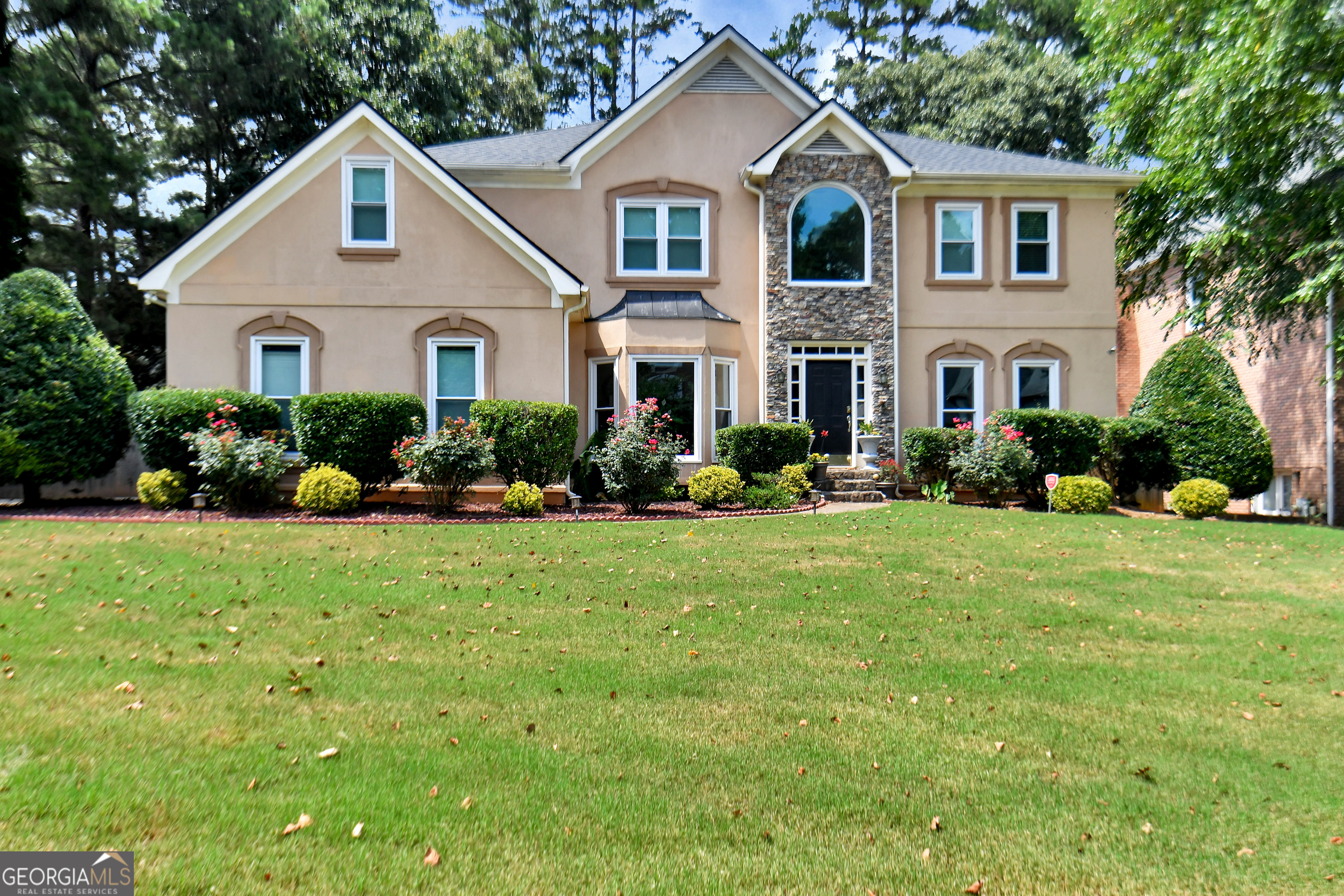 a front view of a house with a yard