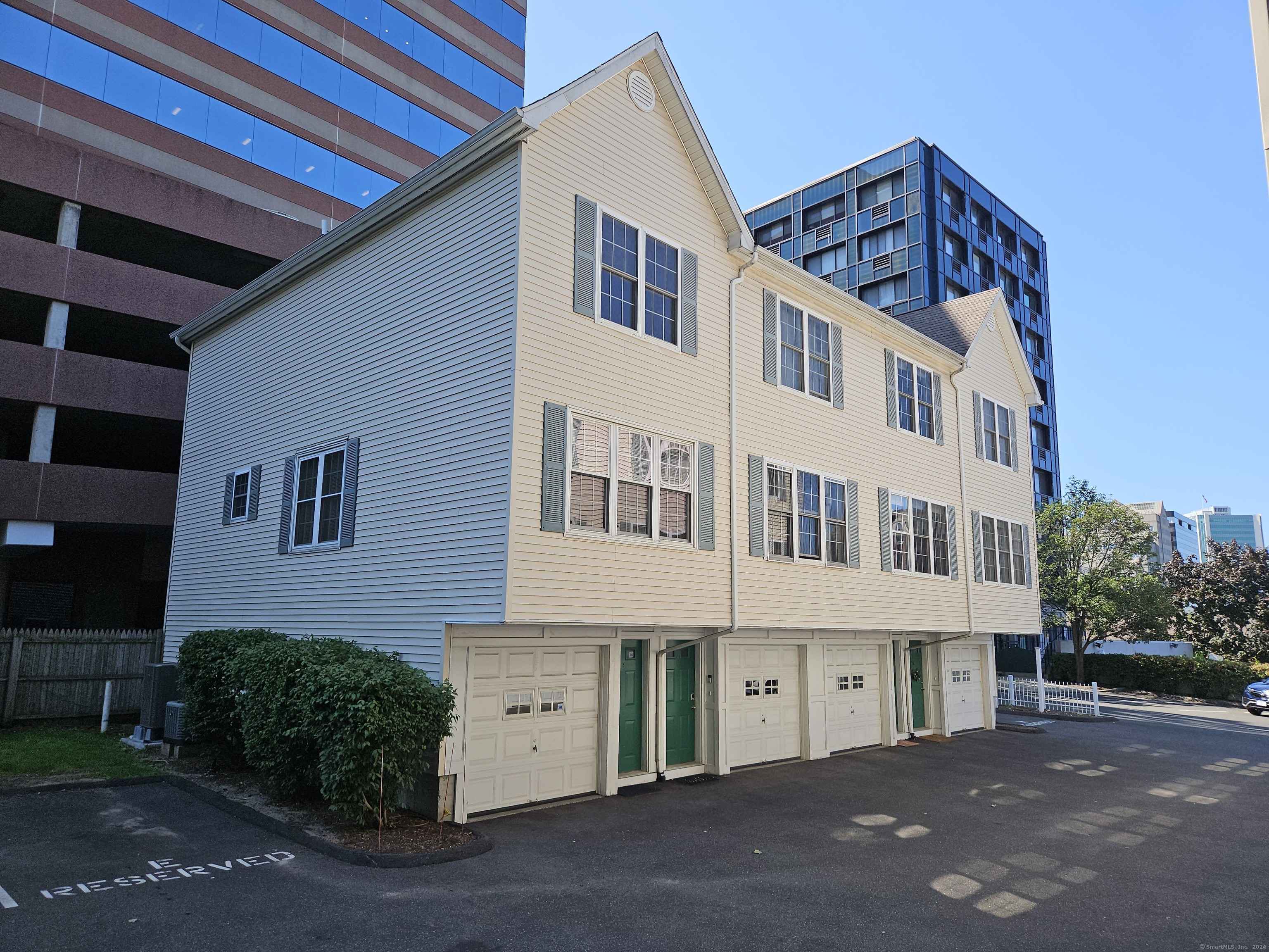 a front view of a building with a garden