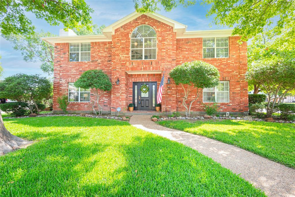 front view of a house with a yard