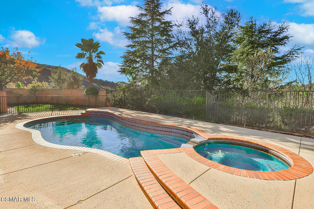 a view of a swimming pool with a yard