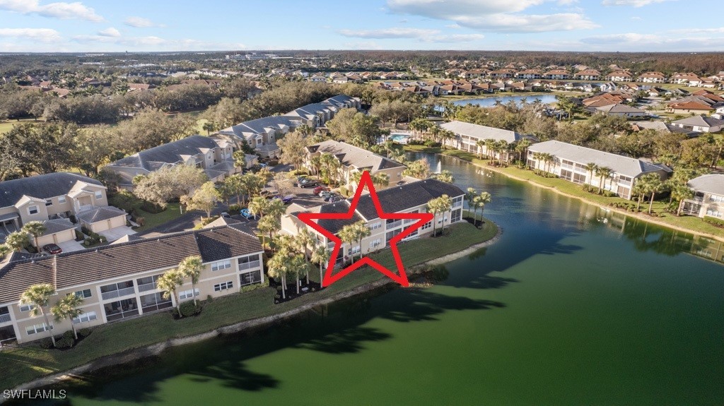 an aerial view of residential houses with outdoor space and lake view