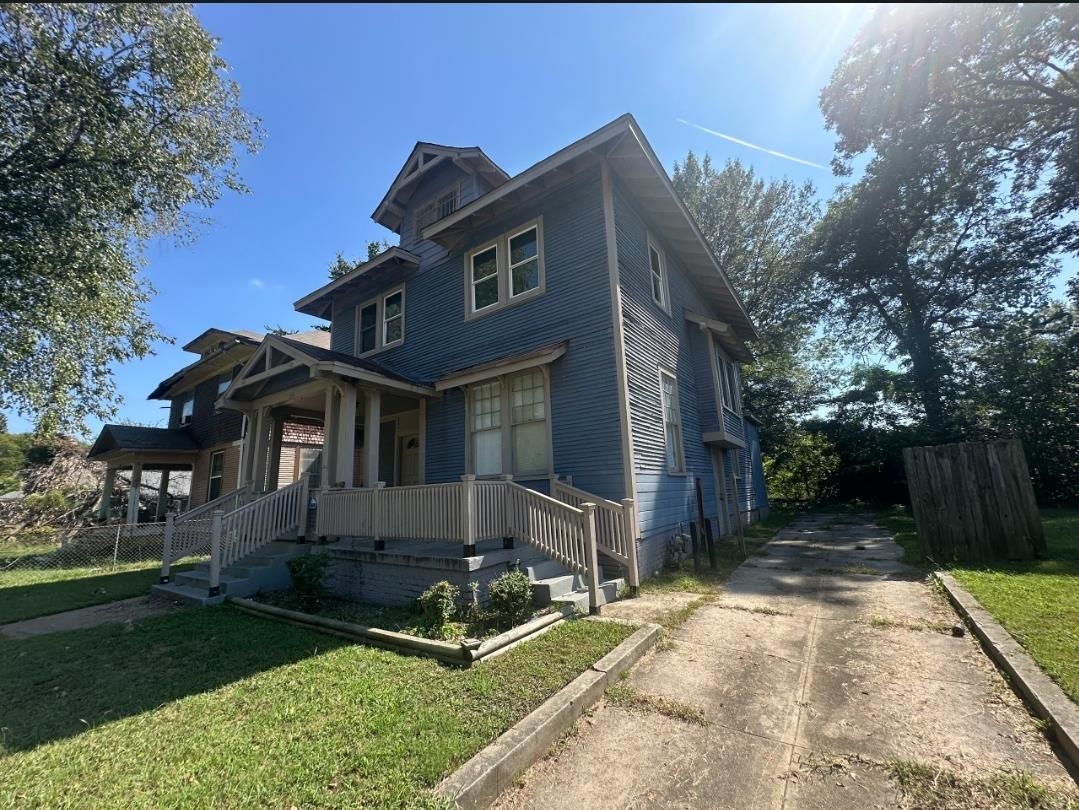 View of front of house with a front lawn and covered porch