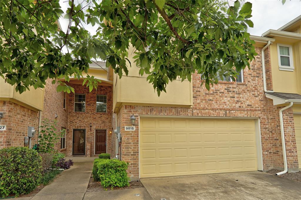 front view of a house with a tree