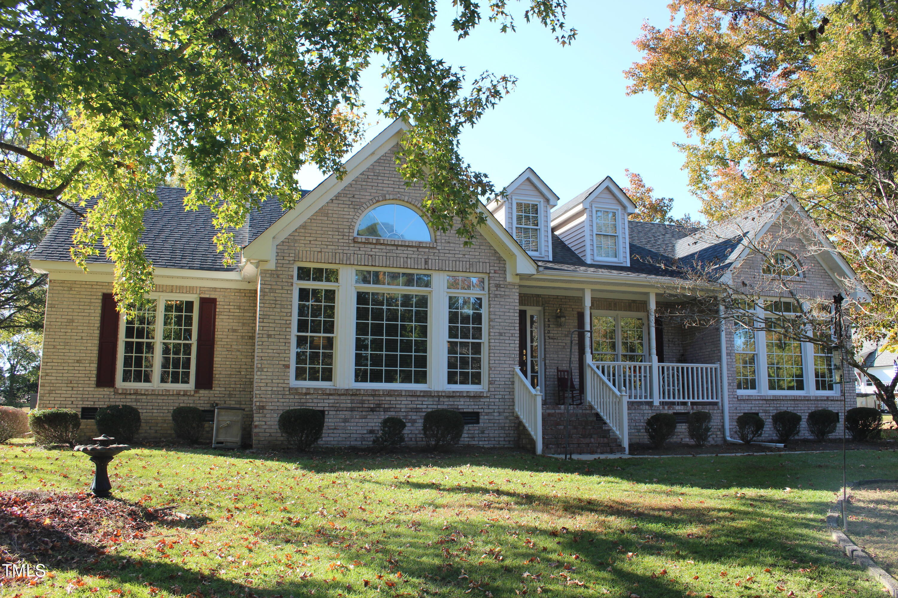 a view of a house with swimming pool and a yard