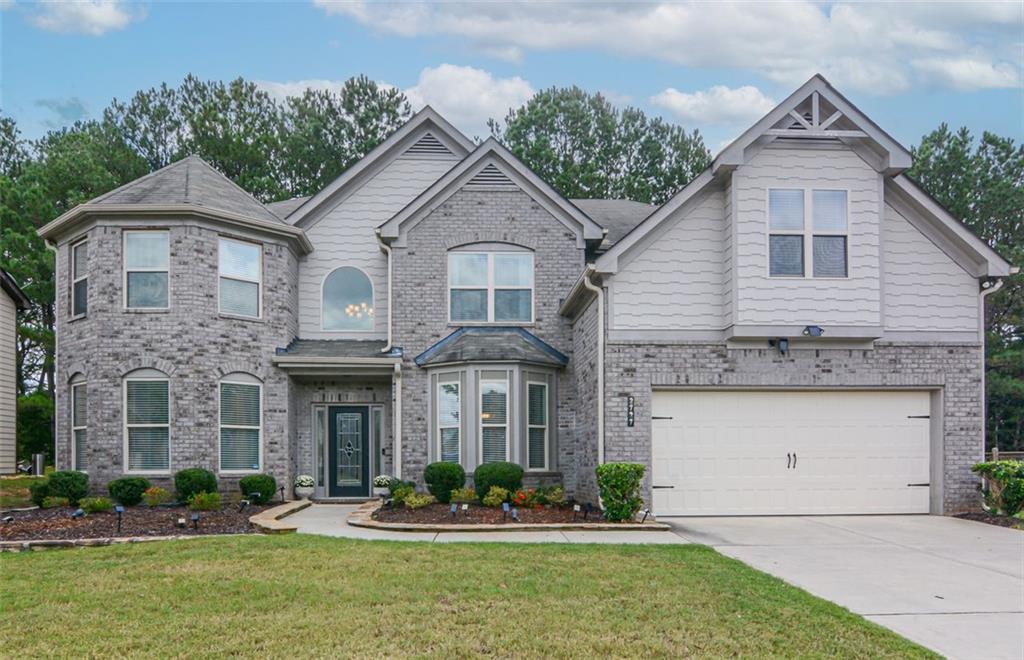 a front view of a house with a yard