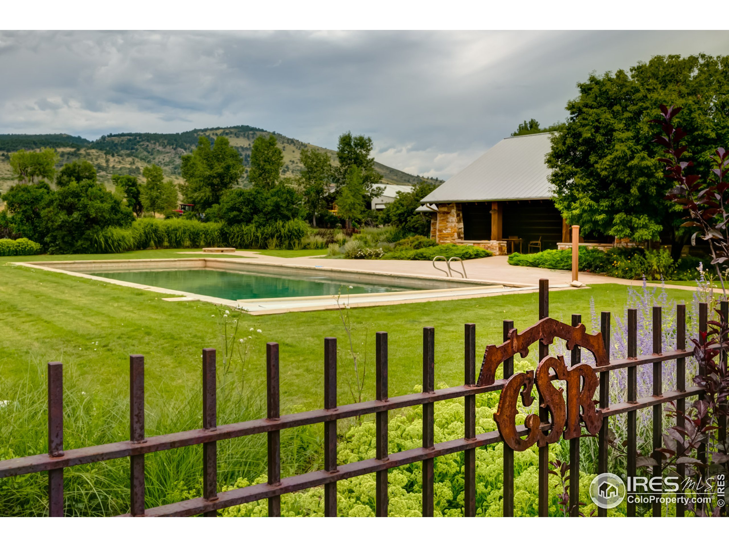 a view of a swimming pool with an outdoor seating and a yard