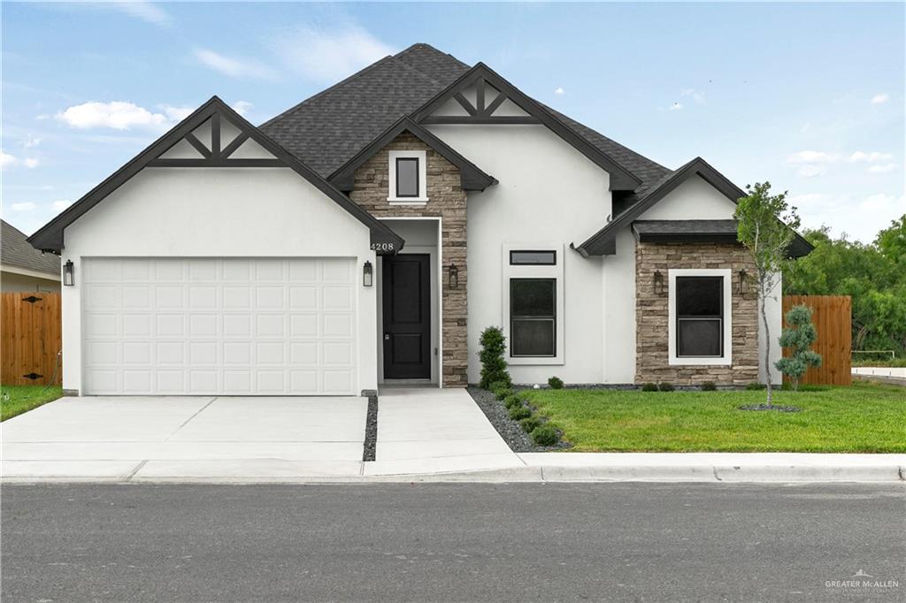 View of front of home featuring a garage and a front yard