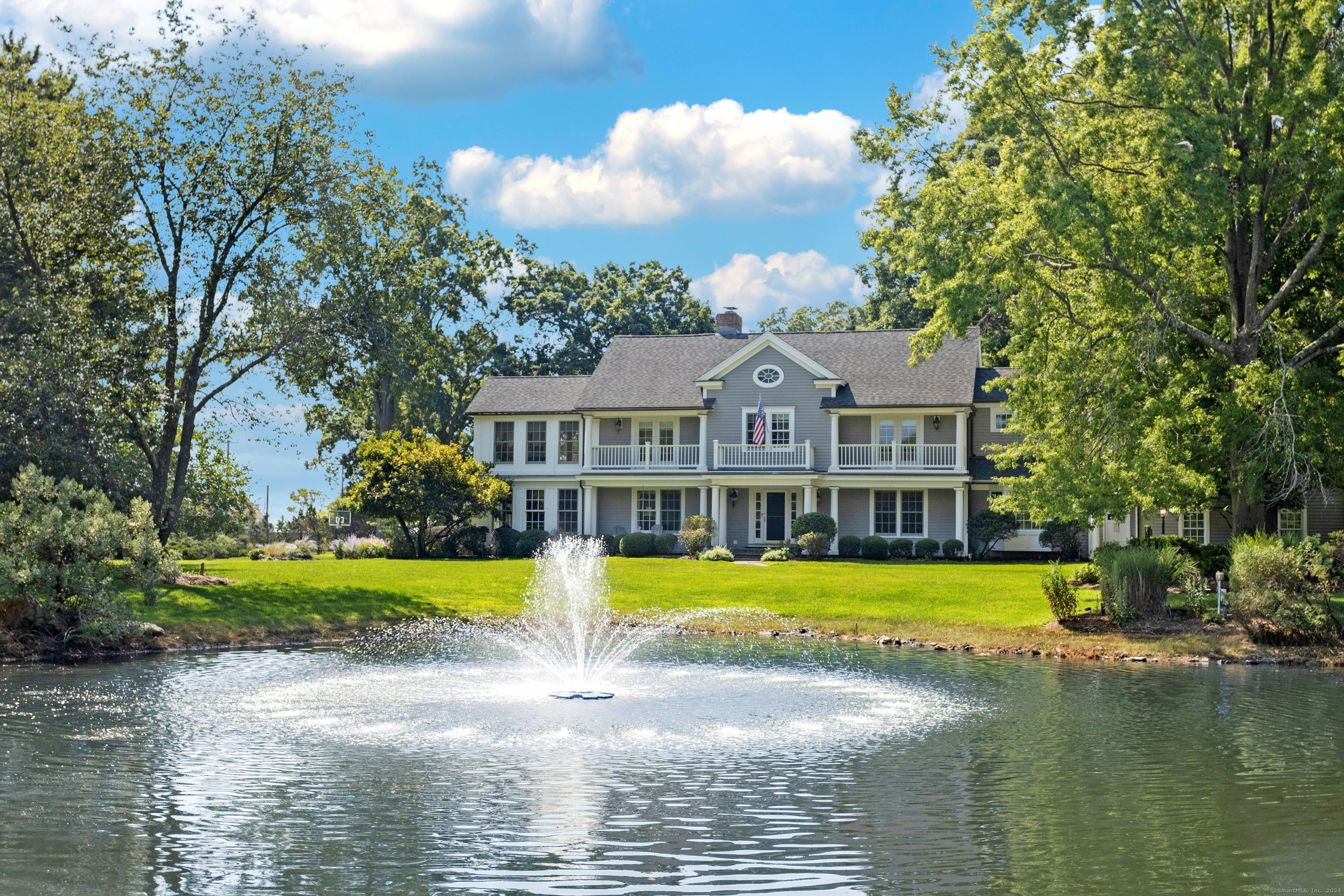 a front view of a house with swimming pool and a yard