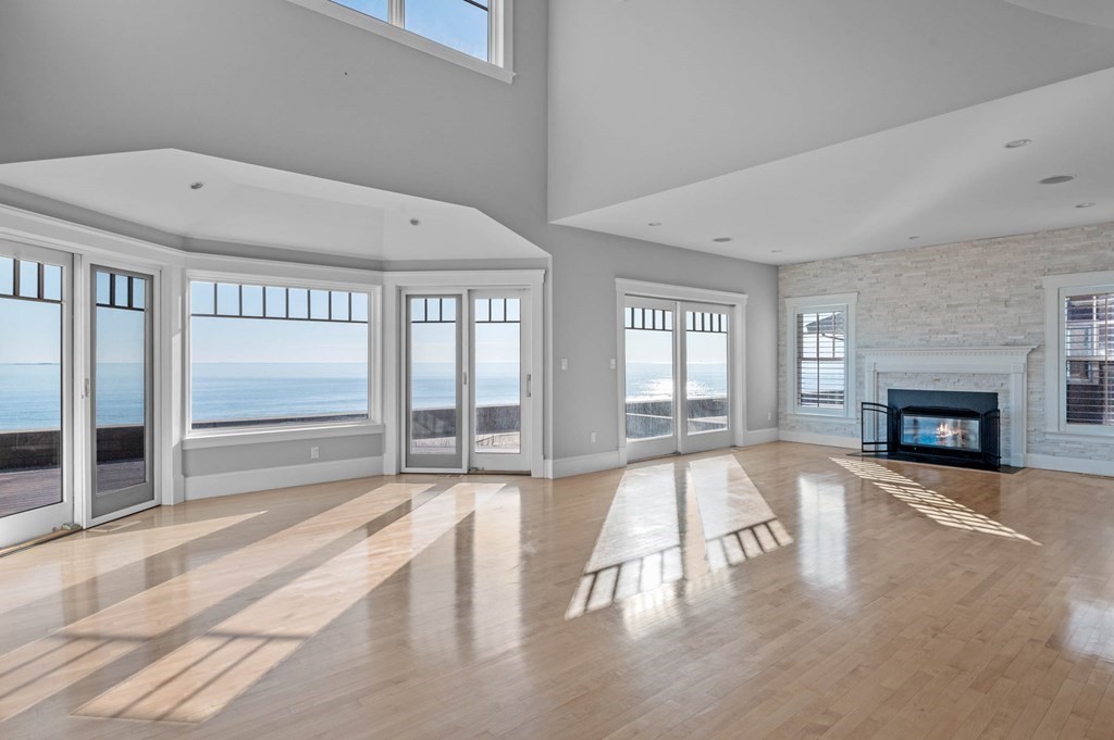 a view of an empty room with a fireplace and a window