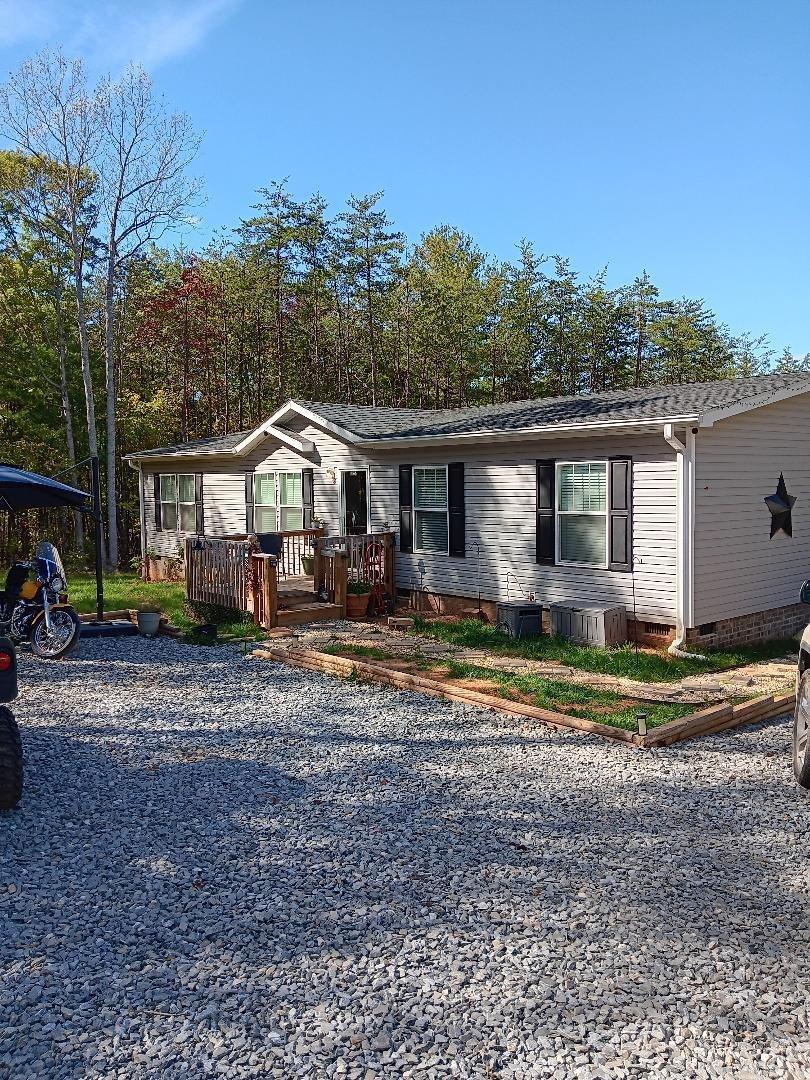 a front view of a house with a yard table and chairs