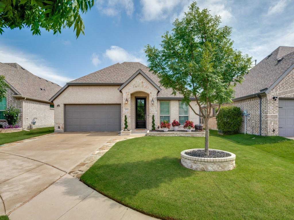 a view of a house with a backyard and a tree