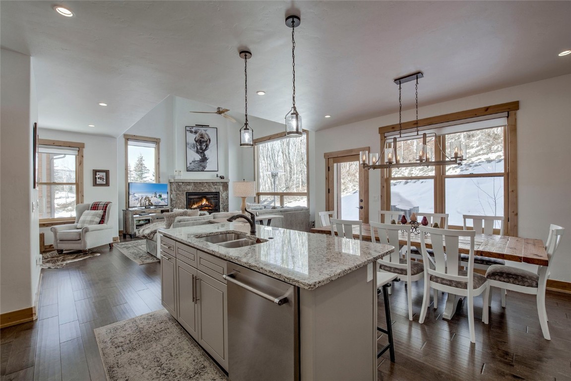 a kitchen with stainless steel appliances granite countertop a stove and a wooden floors