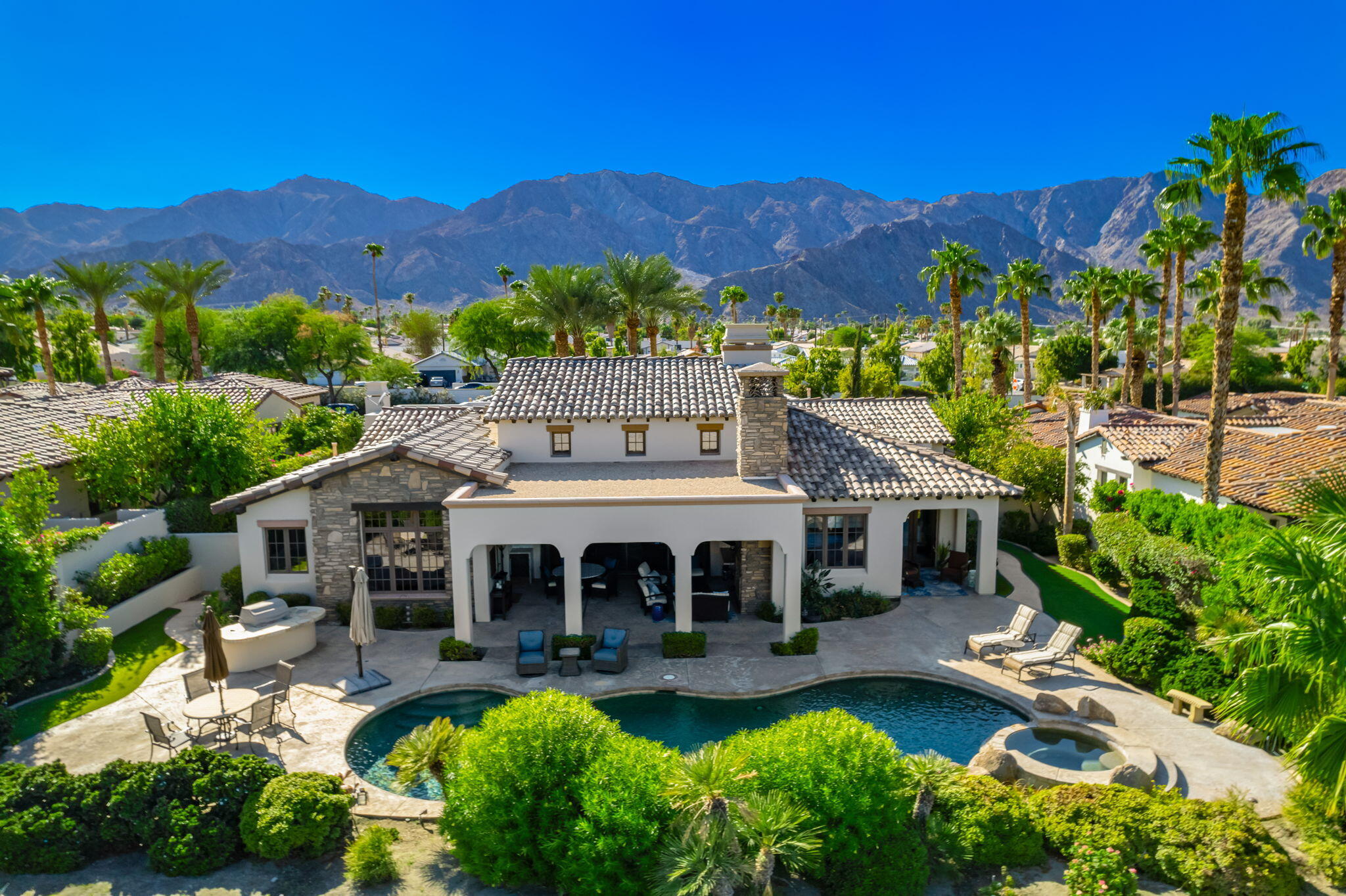 a view of a house with a patio and a garden