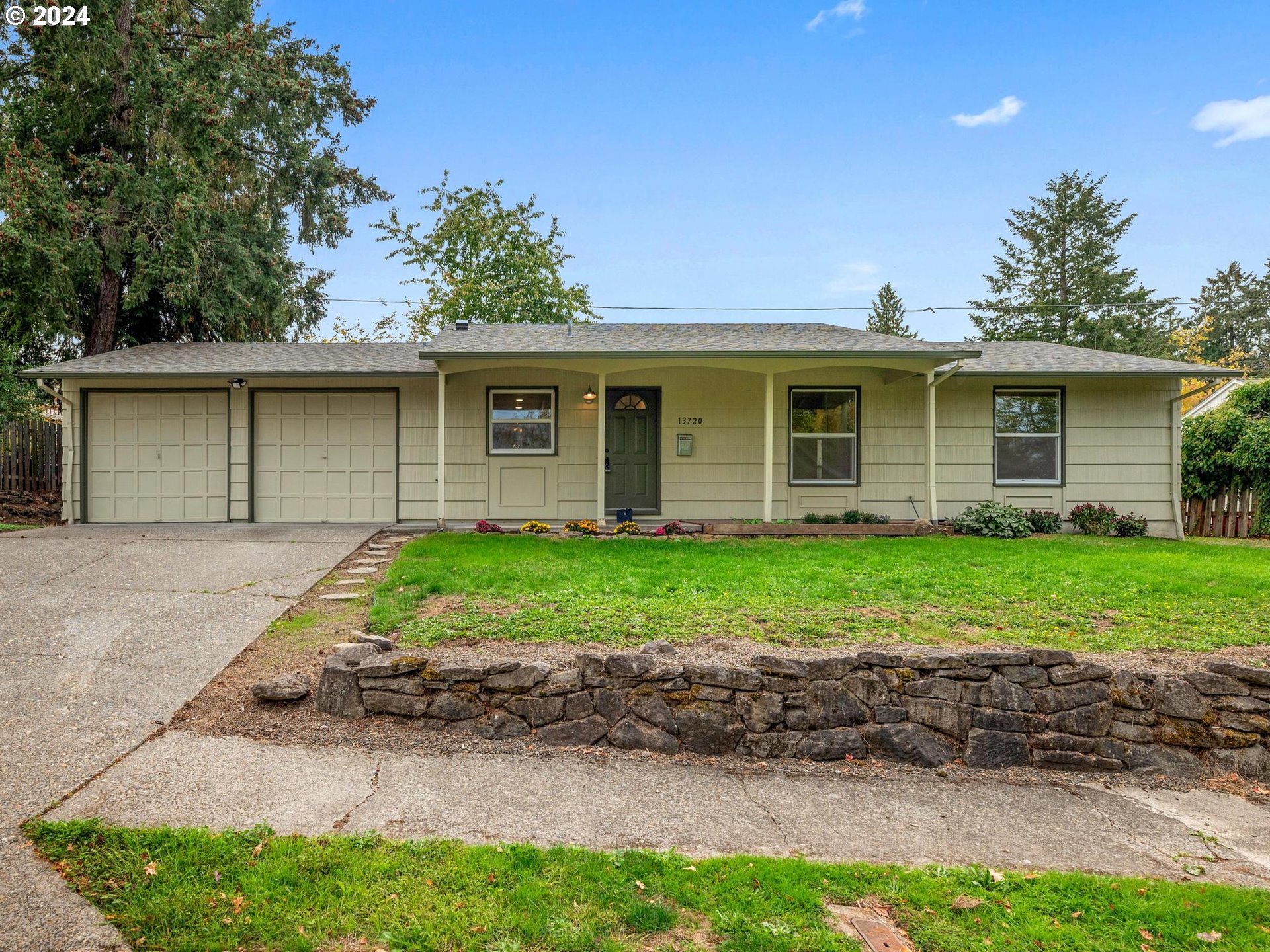 a front view of house with yard and green space