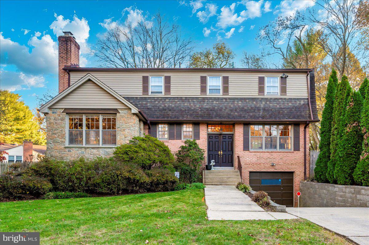 a front view of a house with a garden and yard