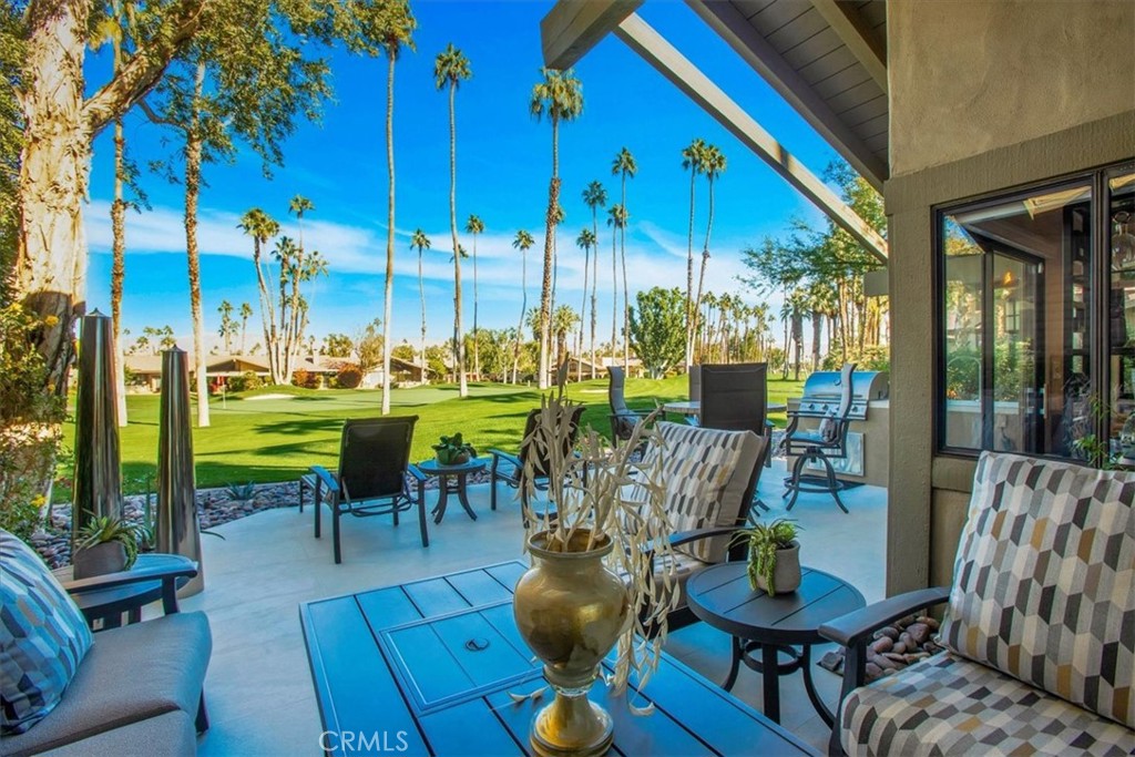 a view of a chairs and table in patio with a fire pit