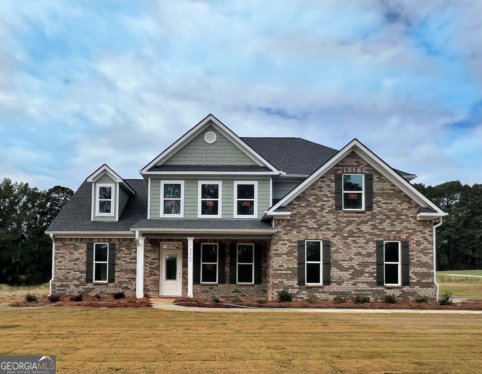 a front view of a house with large windows