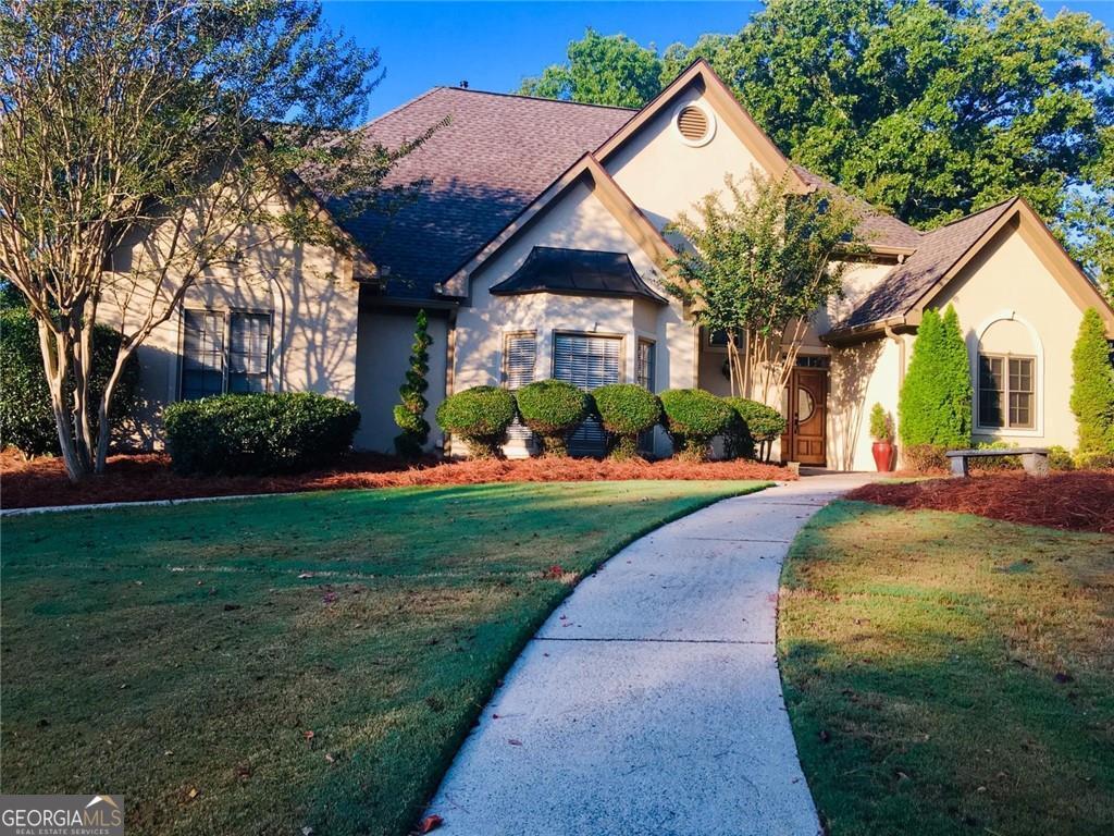 a front view of a house with garden