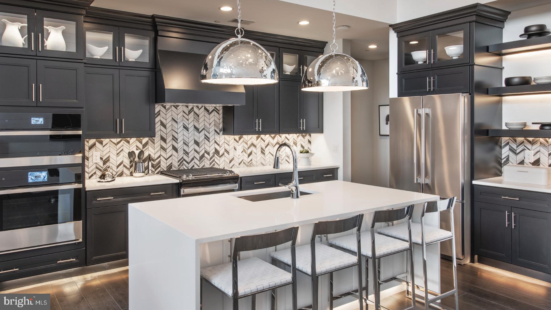 a kitchen with stainless steel appliances wooden floor dining table and chairs