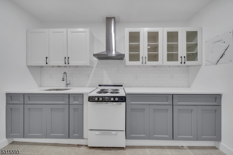 a kitchen with cabinets appliances and a sink