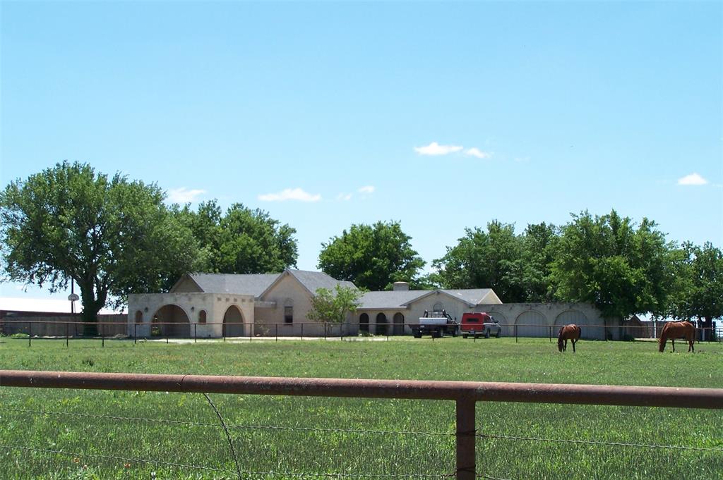 a front view of house with yard and trees