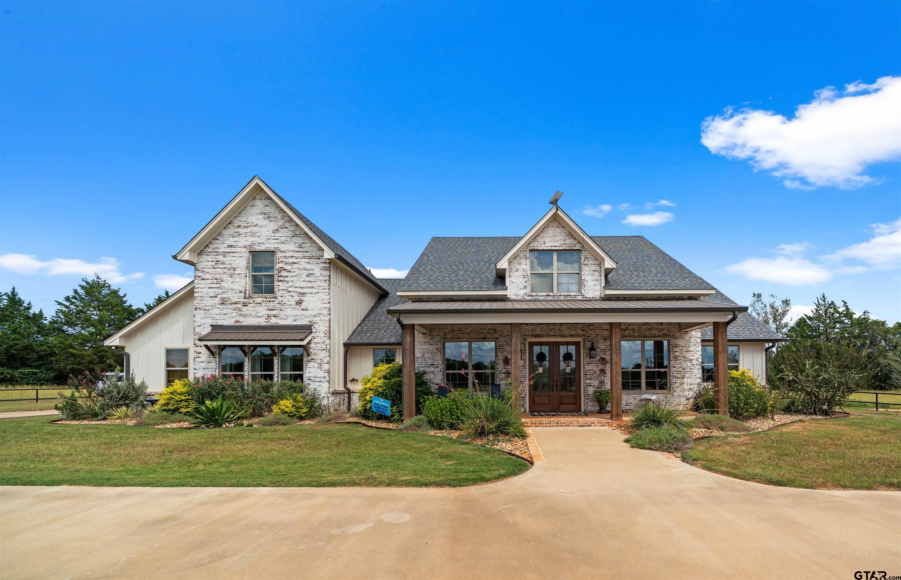 a front view of a house with a yard and porch