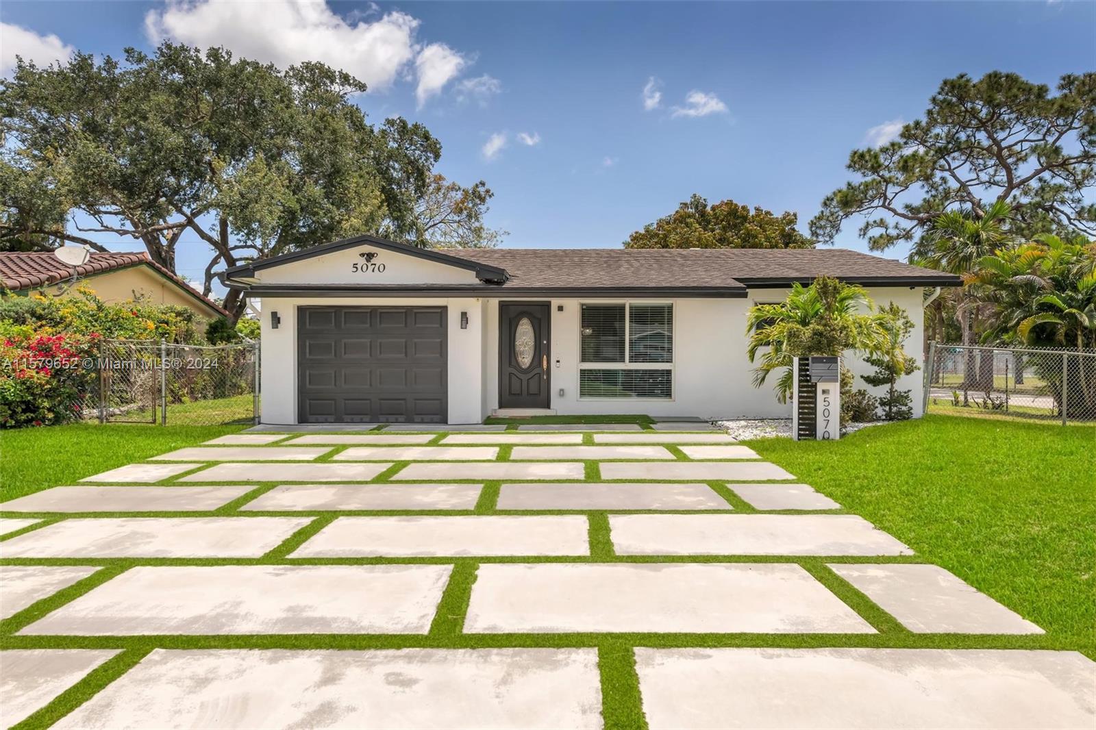 a view of a house with a patio and a yard