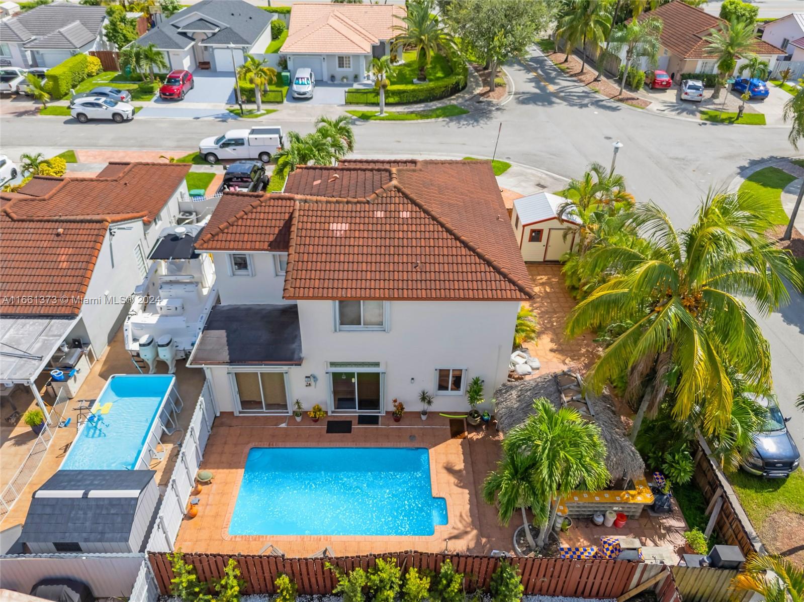 an aerial view of a house with swimming pool garden and patio