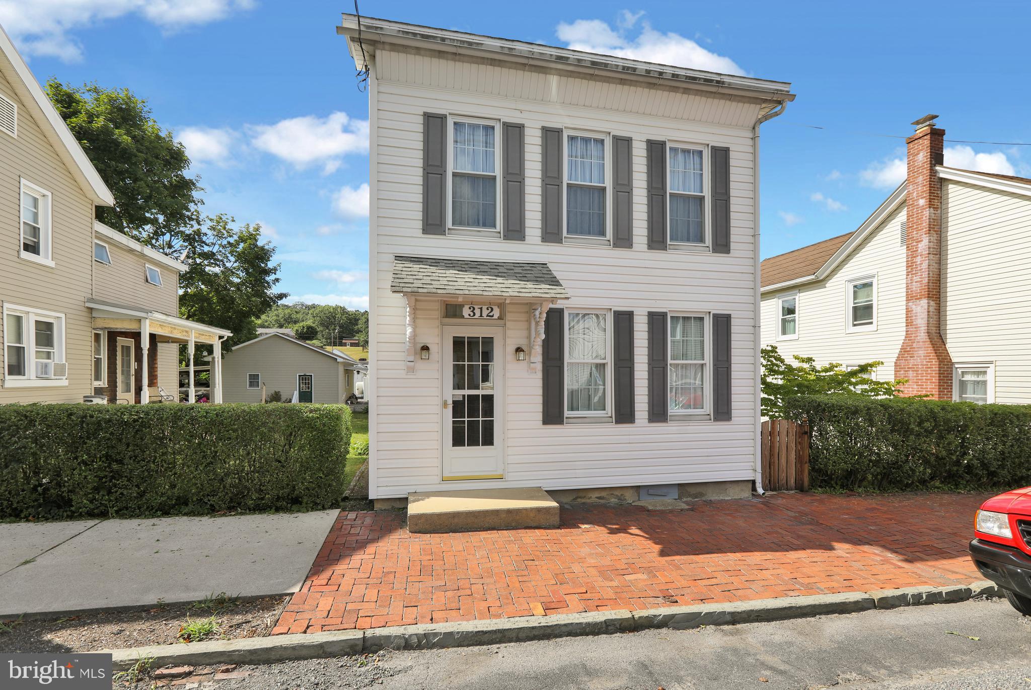 a front view of a house with yard