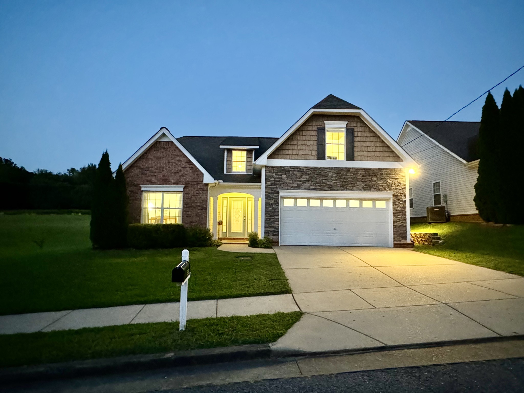 a front view of a house with a yard and garage