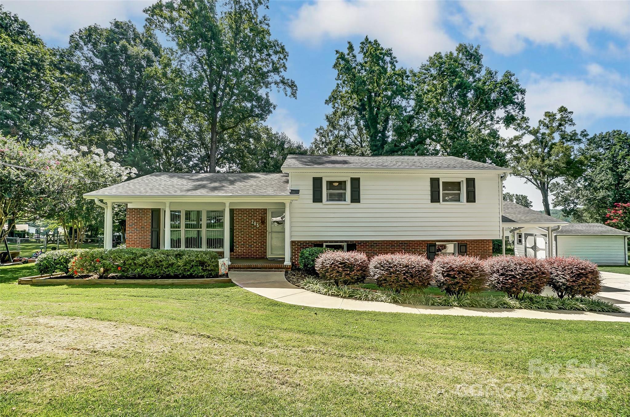 a front view of a house with garden