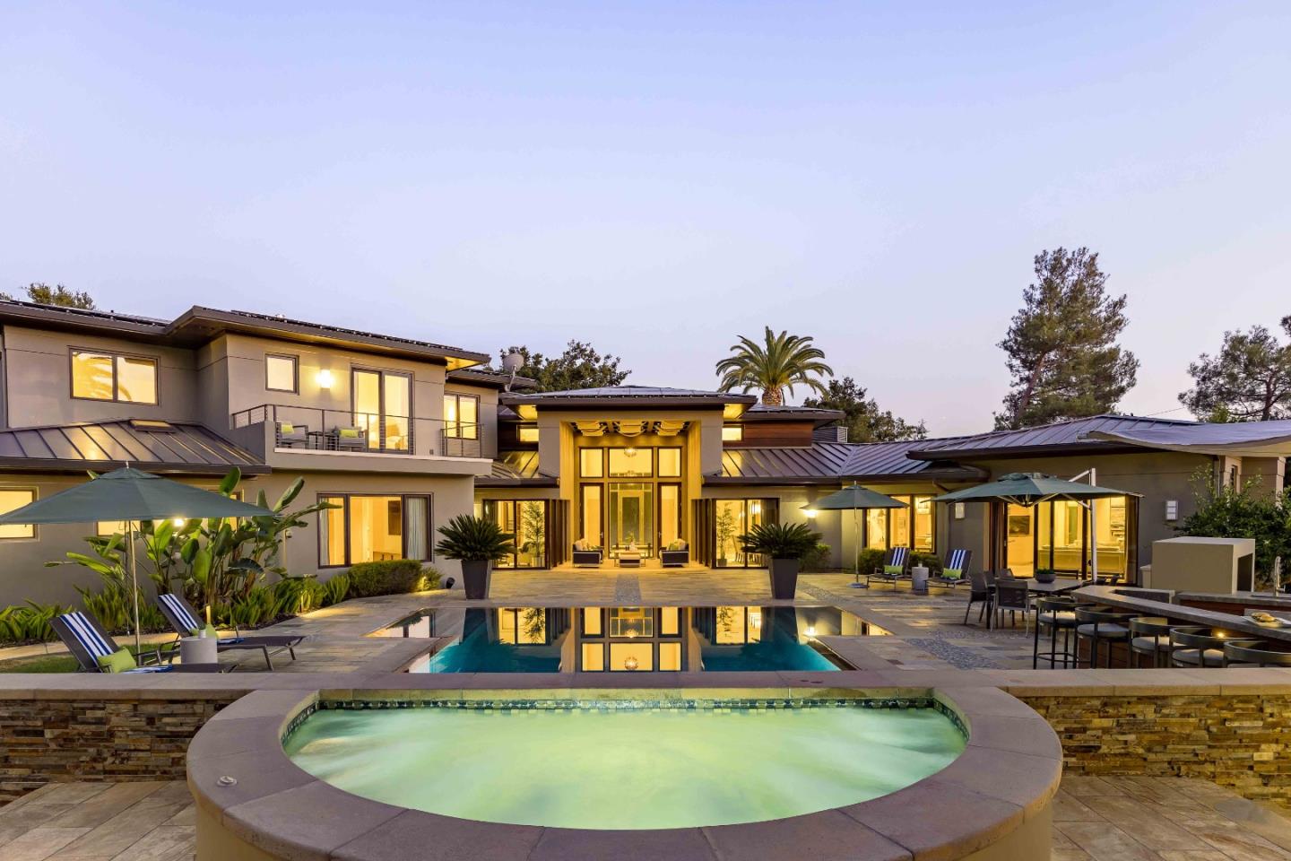 a view of a house with swimming pool and porch