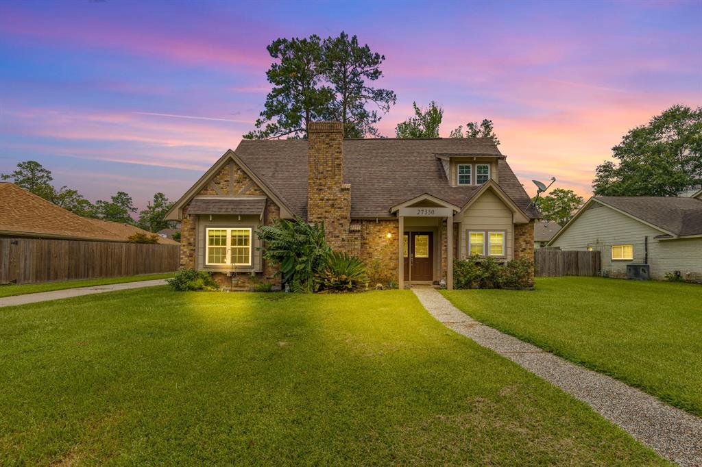 a front view of a house with yard and green space