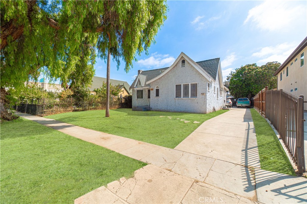 a front view of house with yard and green space