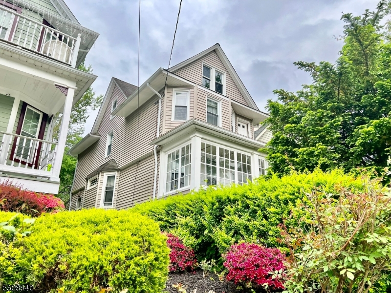 a front view of a house with a yard and fountain