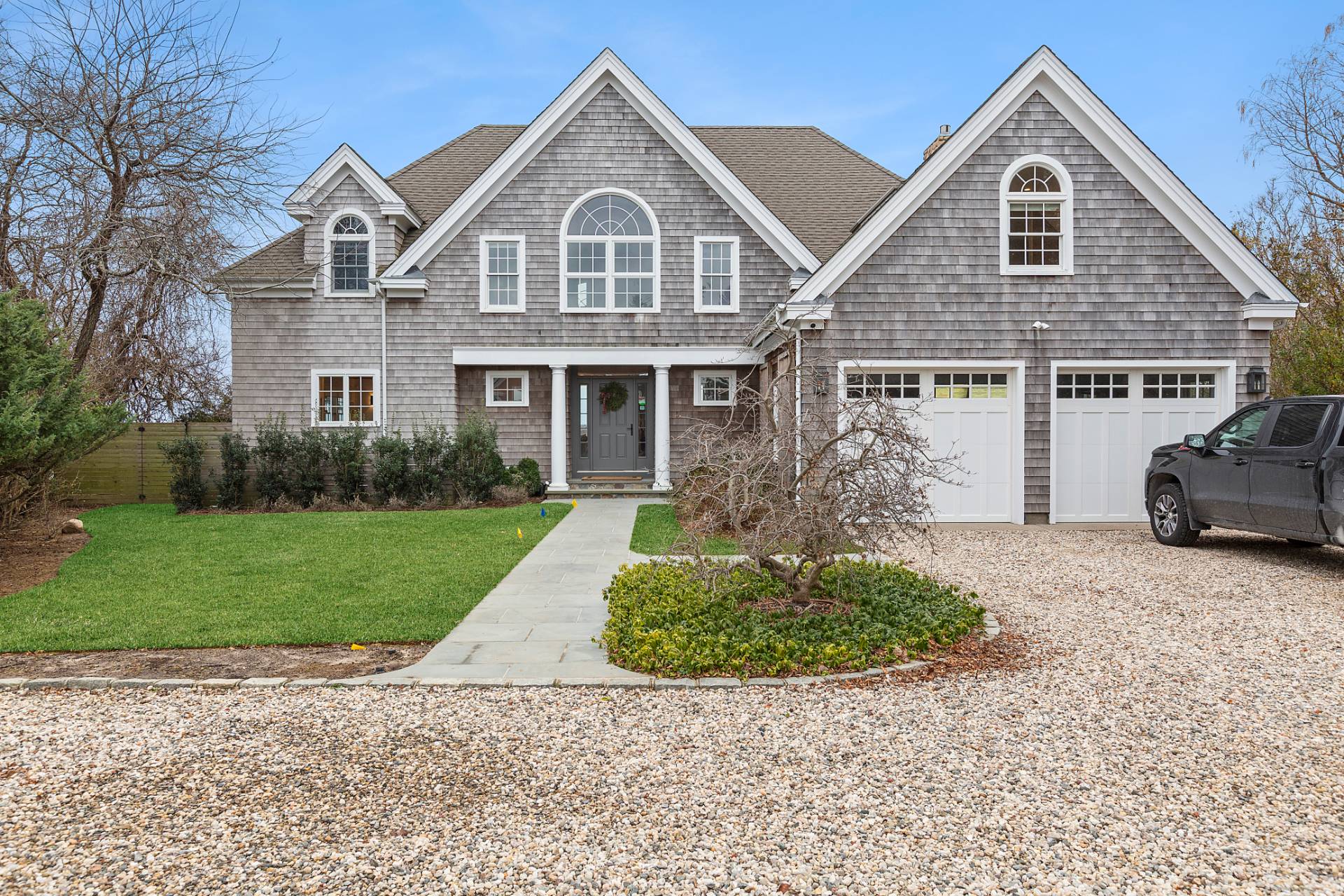 a front view of a house with a yard and garage