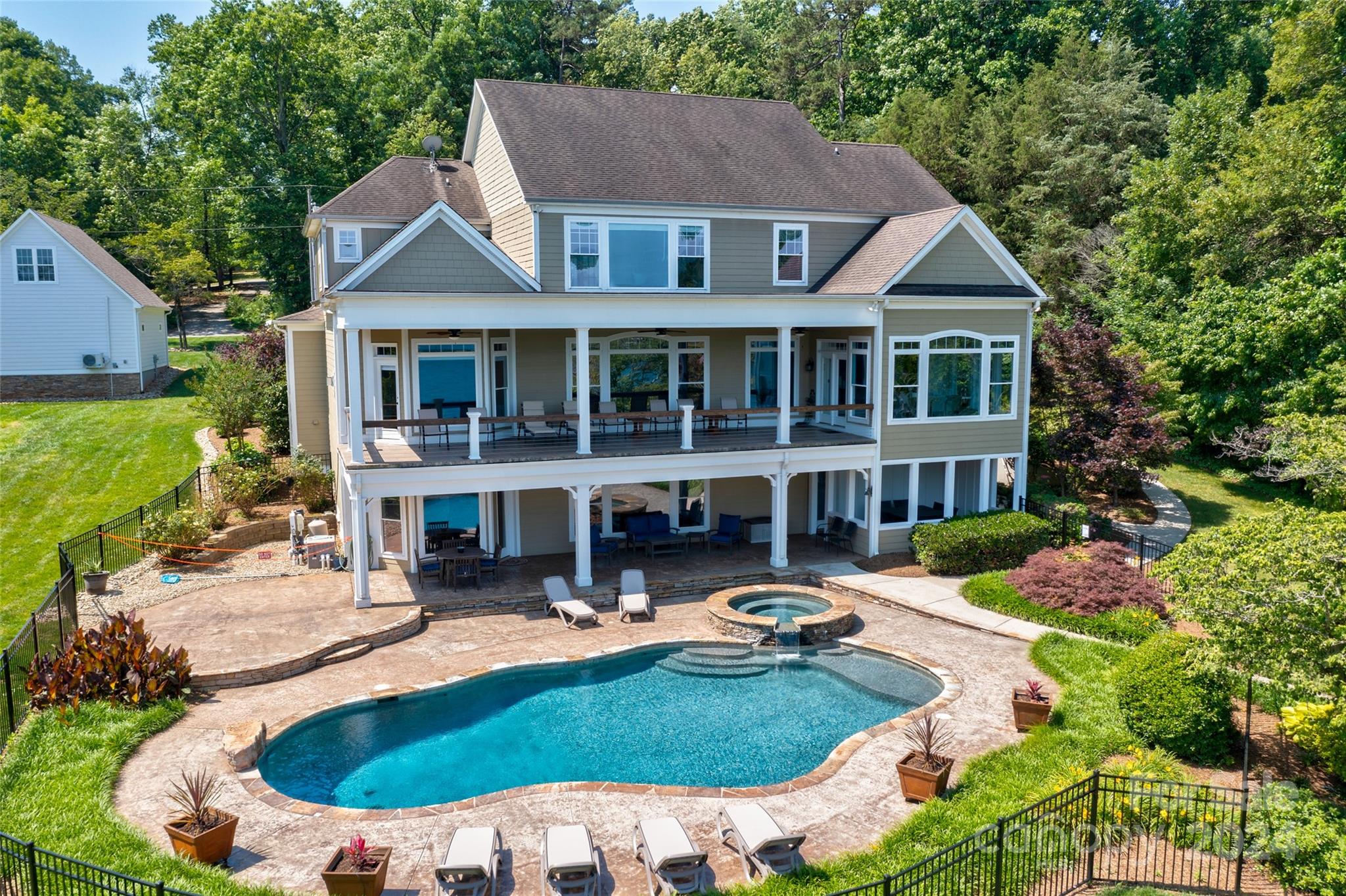 an aerial view of a house with swimming pool and porch