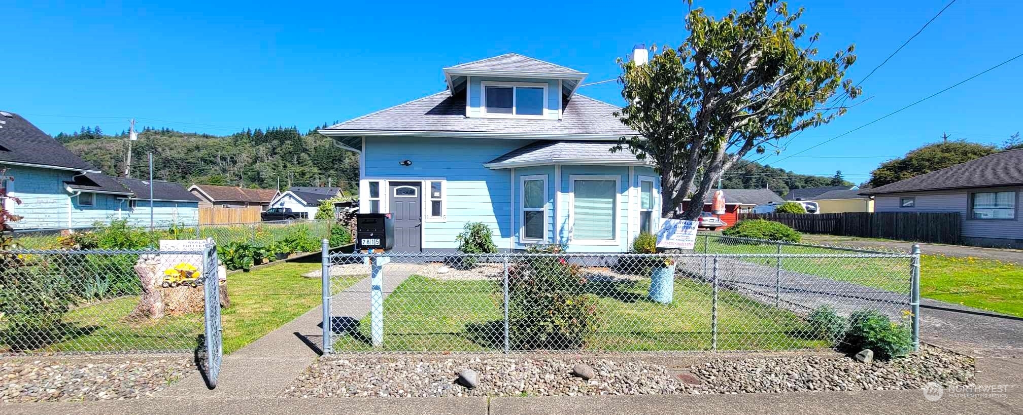 a front view of a house with garden