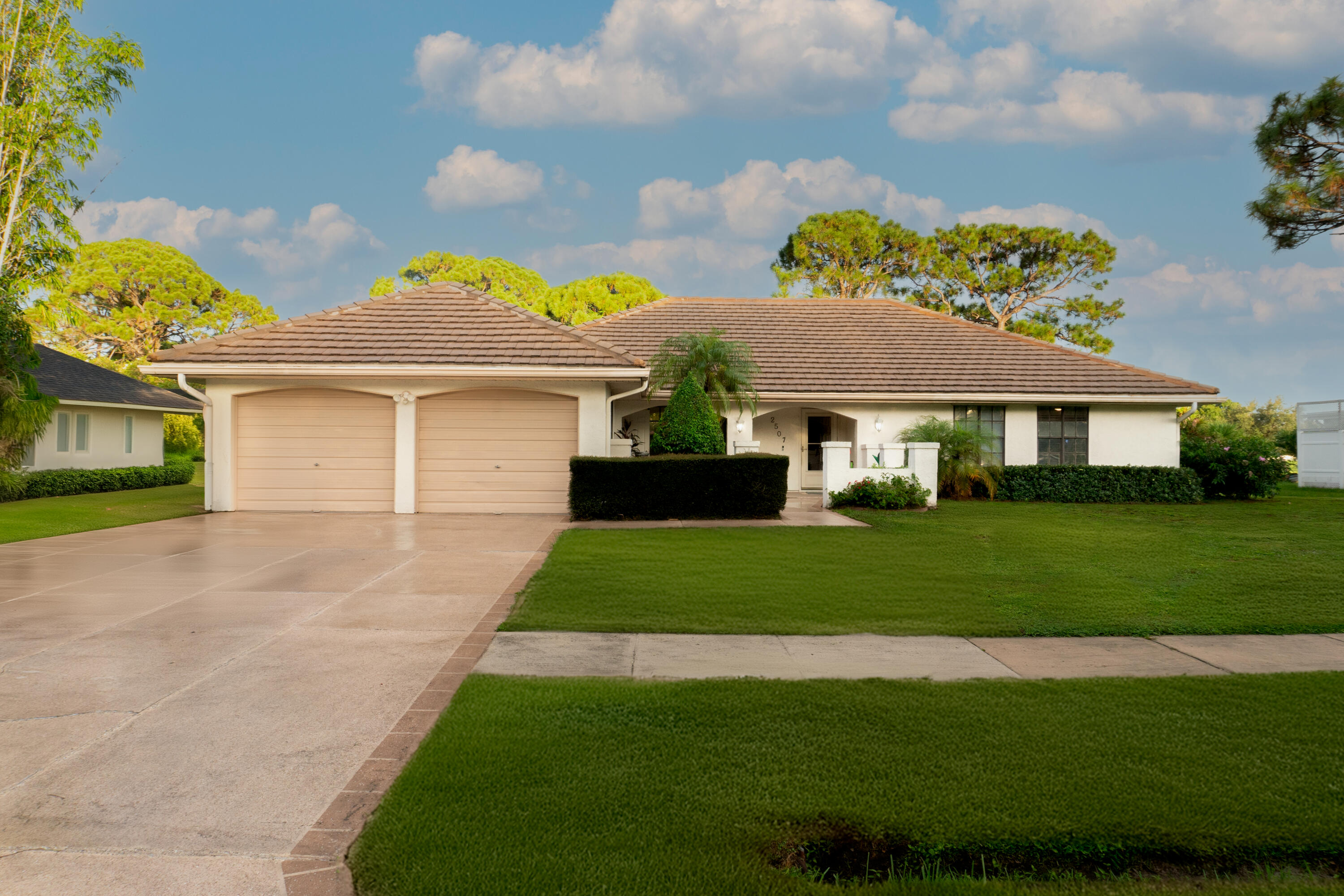 a front view of a house with a garden