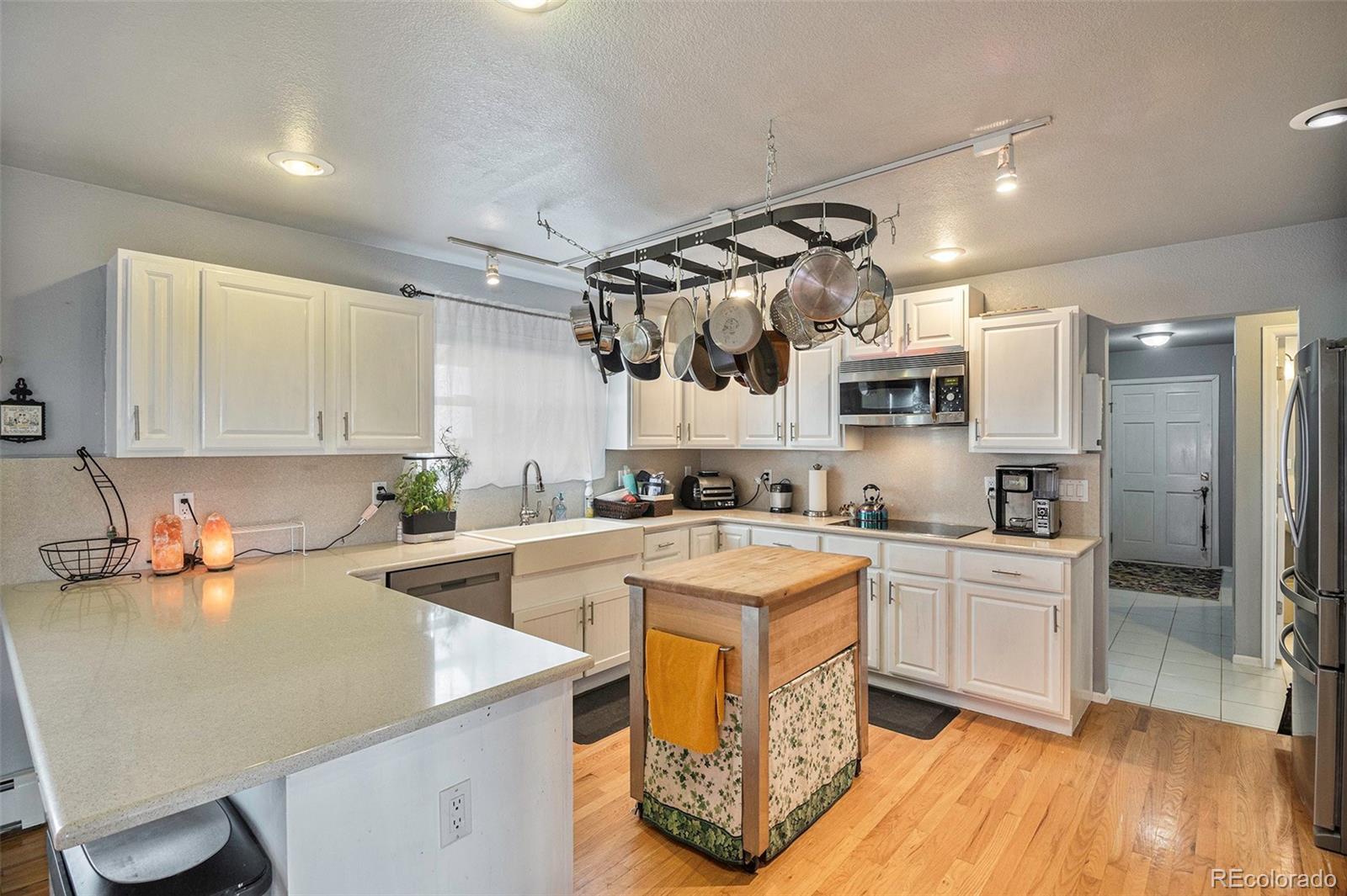 a kitchen with cabinets a sink and appliances