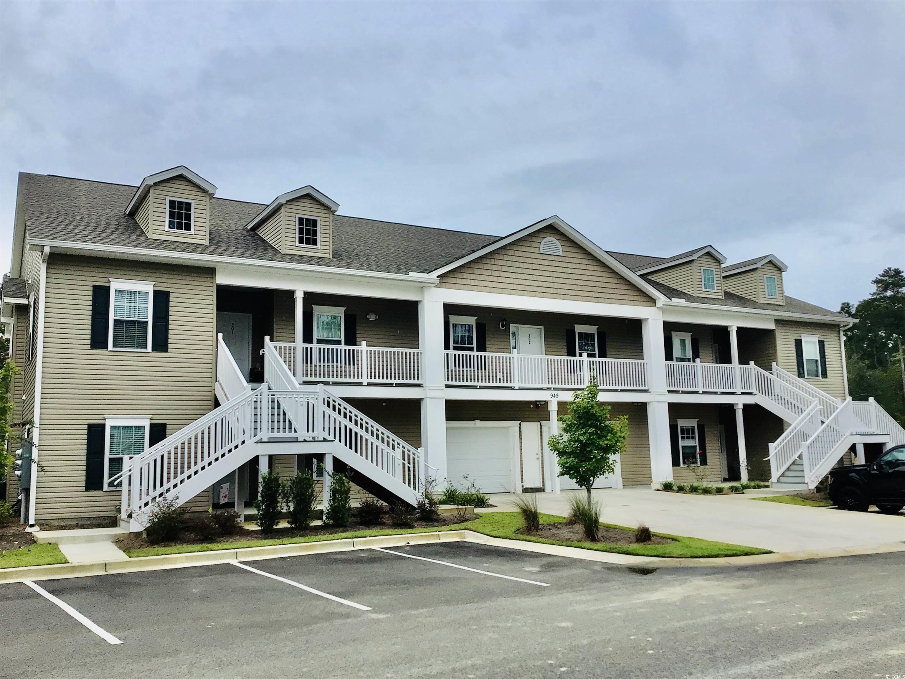 View of front of house with a porch and a garage