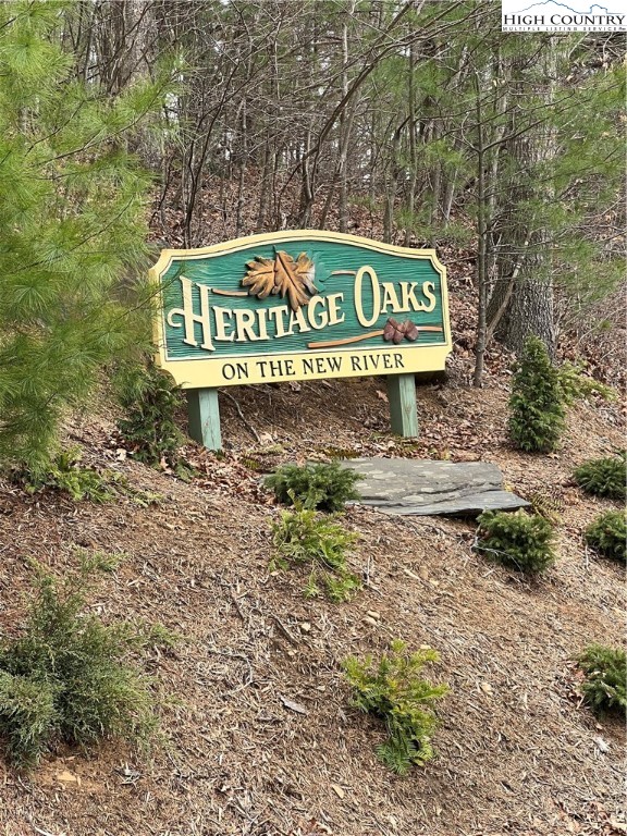 a sign broad in front of a red brick house