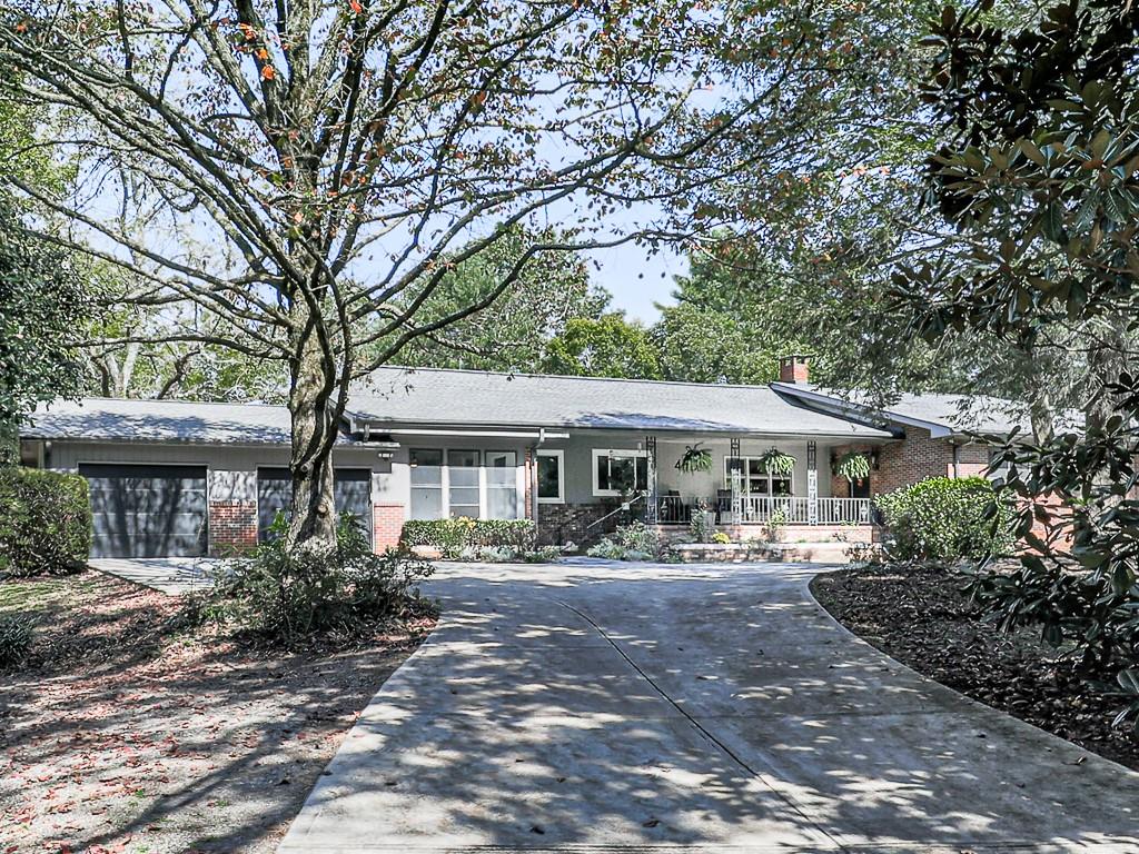 a front view of a house with a garden