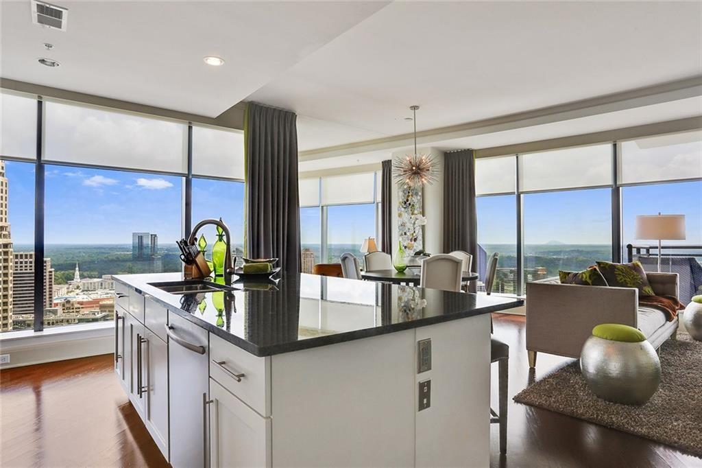 a kitchen with stainless steel appliances granite countertop a sink and a counter top space