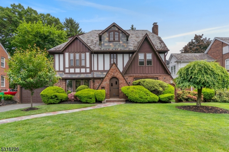 a front view of a house with garden