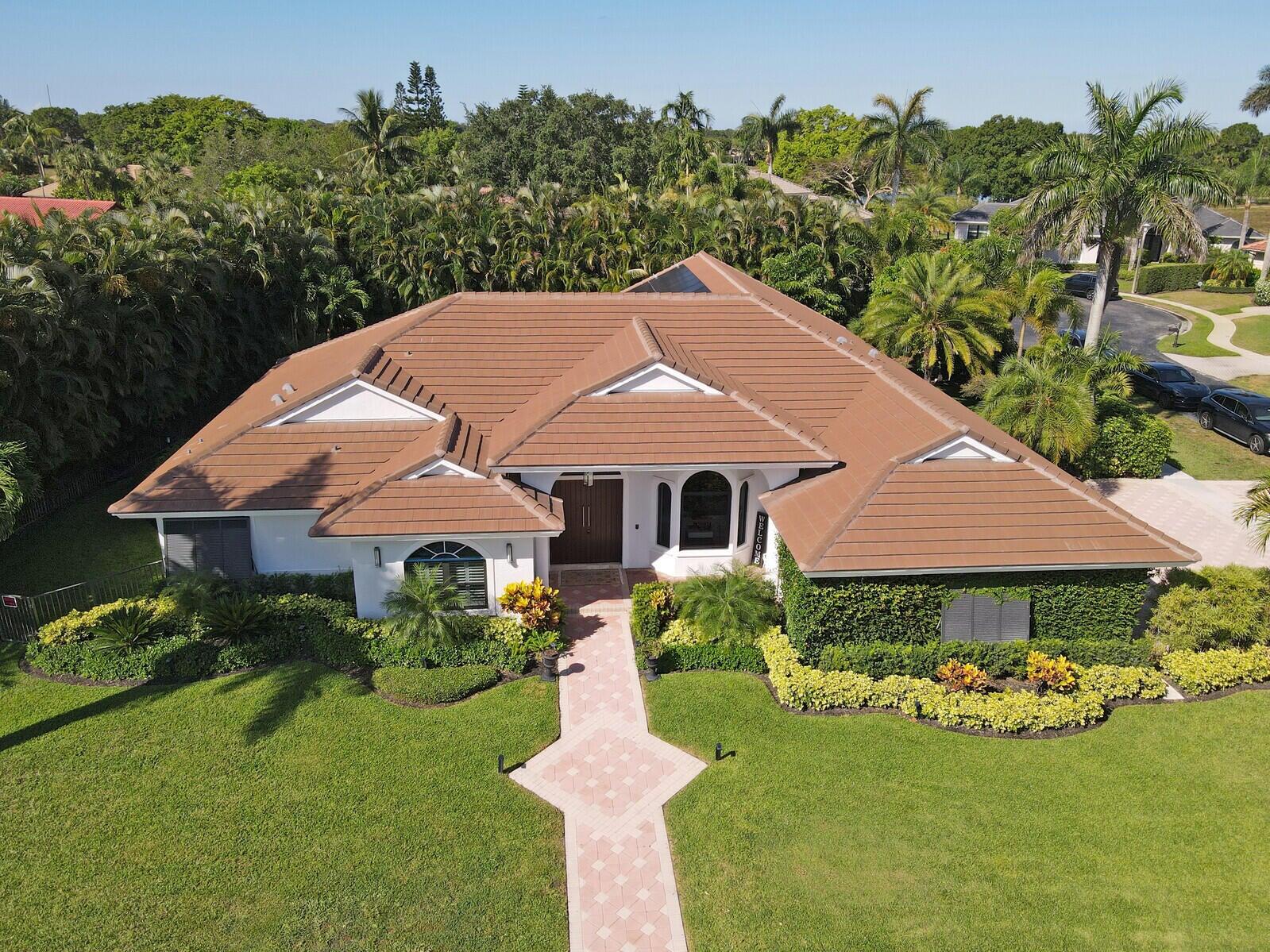 a aerial view of a house next to a yard