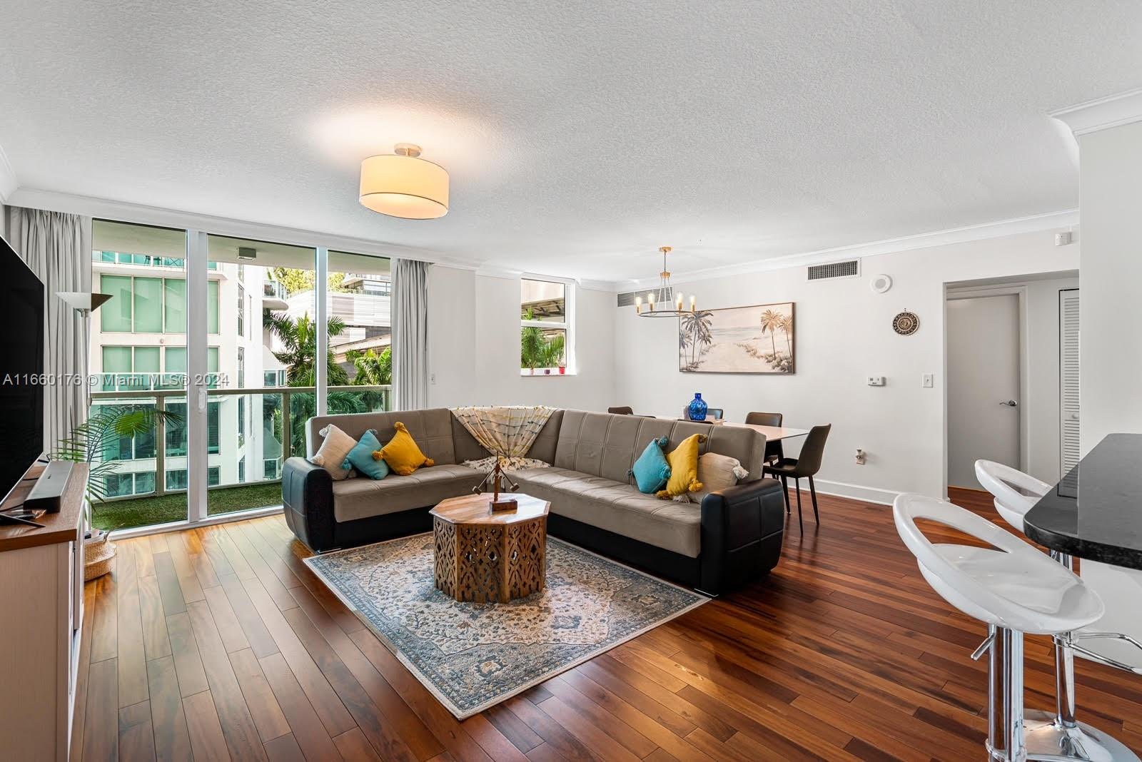 a living room with furniture rug and wooden floor